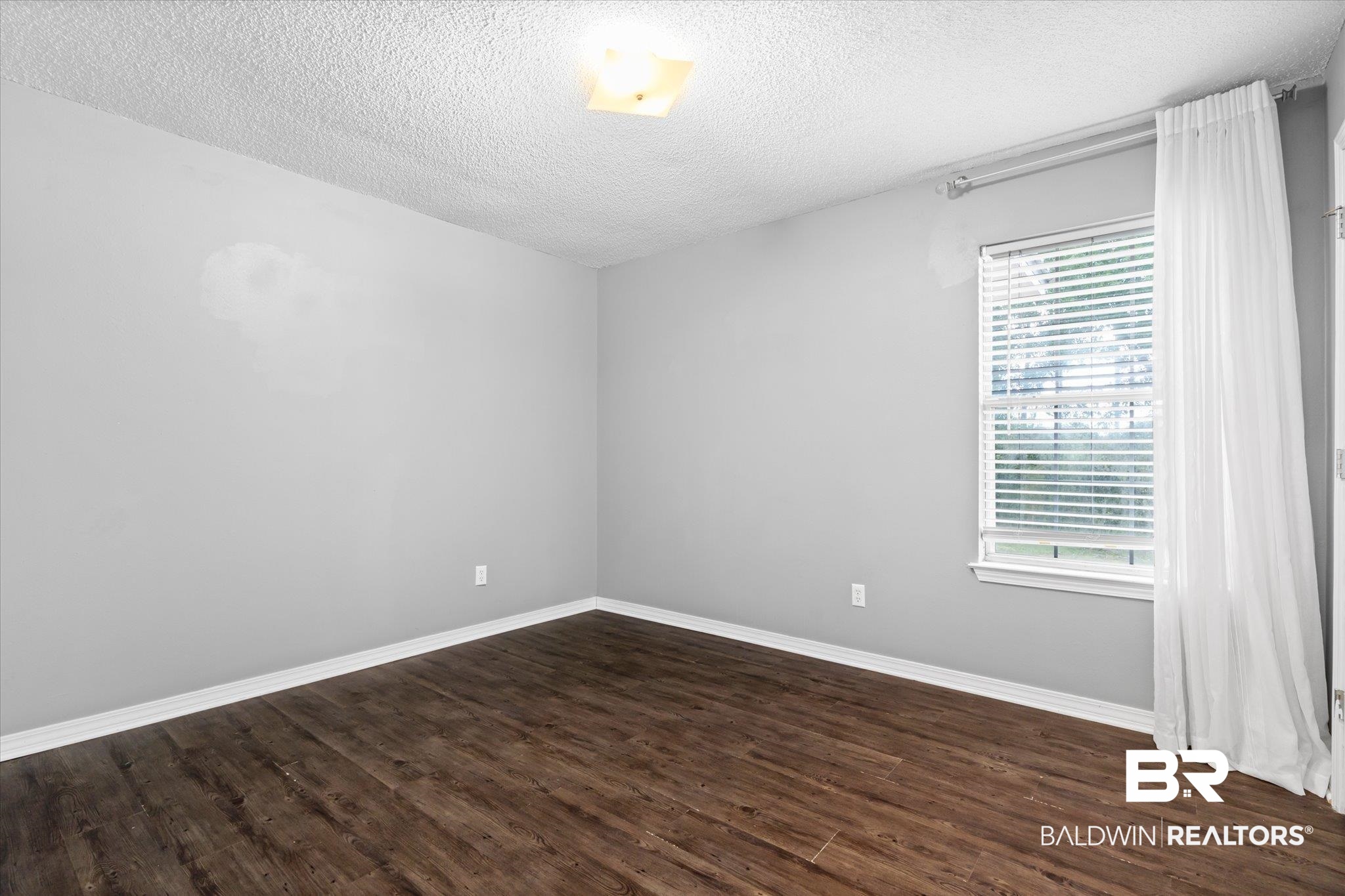 16216 Pointer Drive Foley, AL 36535 - Photo 14 of 21 Room featuring wood-finish flooring, light grey painted walls, and white trim
