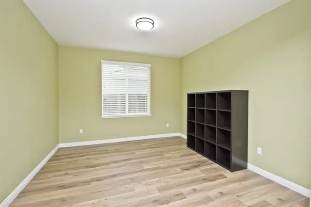 a view of wooden floor and windows in a room