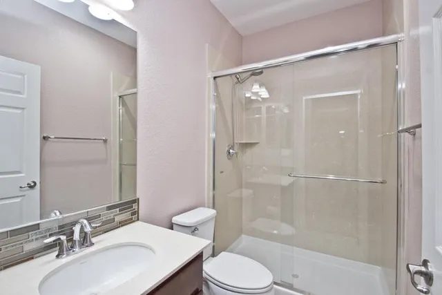 a bathroom with a sink toilet and shower