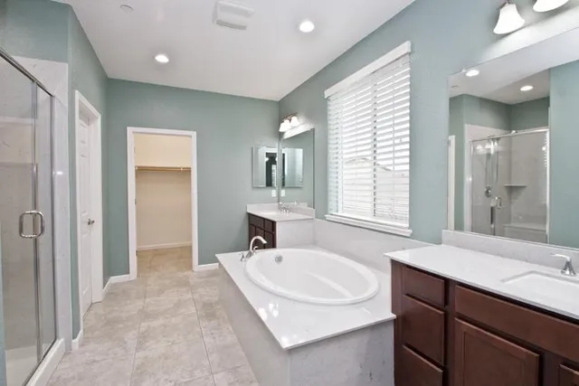 a bathroom with a sink double vanity and a mirror