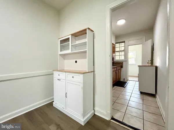 a kitchen with white cabinets and refrigerator
