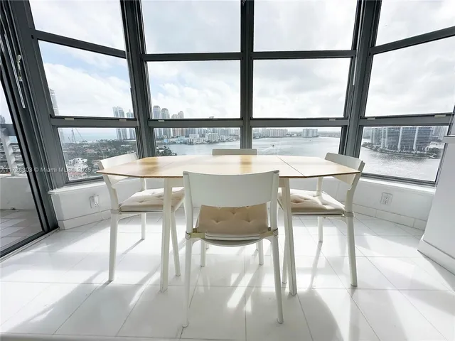 a dining room with a table and chairs