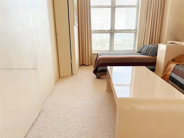 a view of a room with a bed and a window