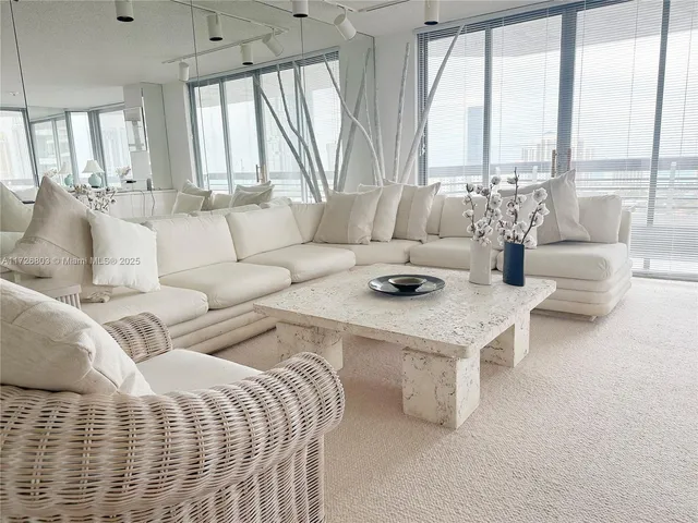 a living room with furniture and a floor to ceiling window