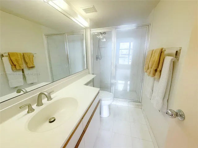 a bathroom with a tub sink a mirror and shower