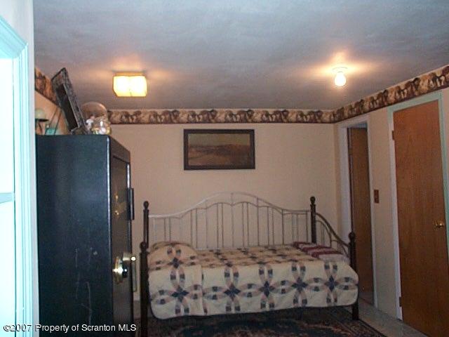 6147 Rr 6 Carter Road Montrose, PA 18801 - Photo 10 of 13 a bedroom with a bed window and a walk in closet