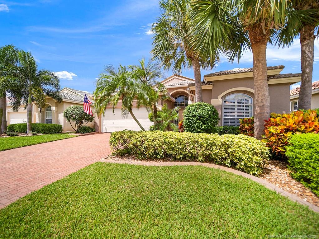 1136 Southeast Westminster Place Stuart, FL 34997 - Photo 1 of 36 a front view of a house with a garden