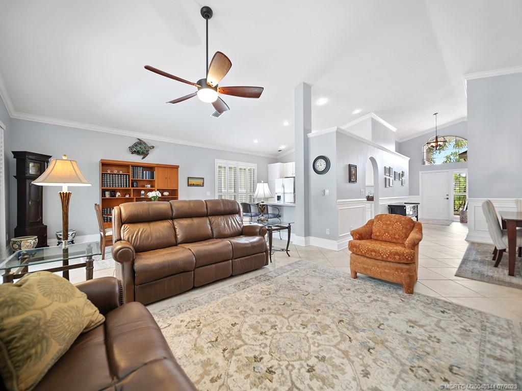 1136 Southeast Westminster Place Stuart, FL 34997 - Photo 11 of 36 a living room with furniture and kitchen view