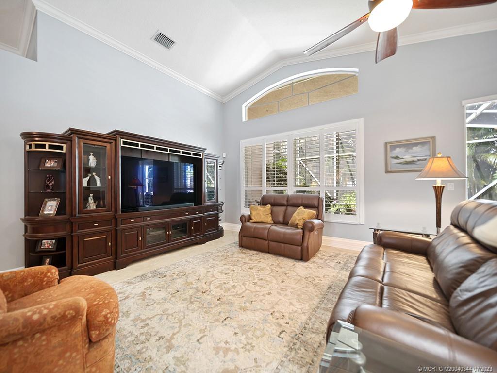 1136 Southeast Westminster Place Stuart, FL 34997 - Photo 13 of 36 a living room with furniture and a flat screen tv