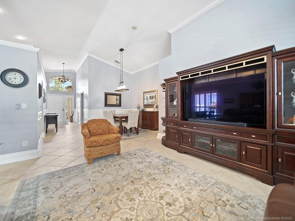 1136 Southeast Westminster Place Stuart, FL 34997 - Photo 14 of 36 a living room with furniture and a flat screen tv