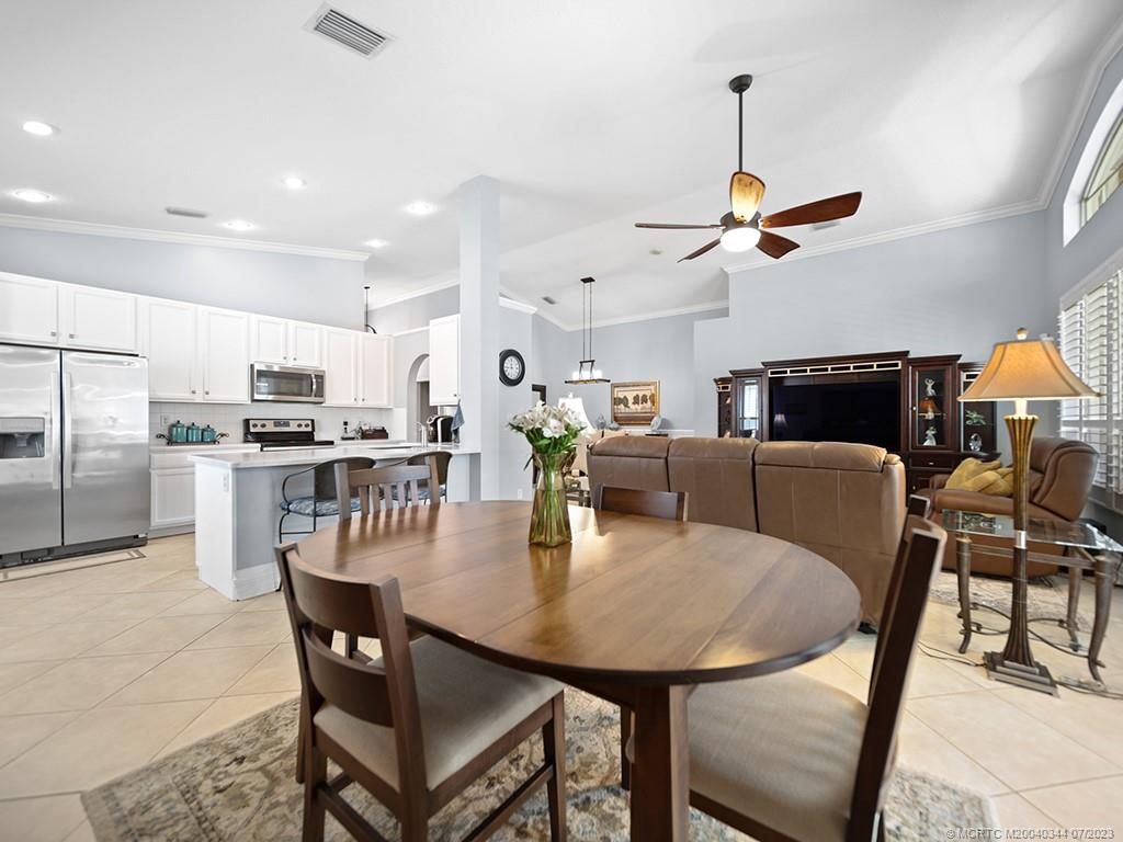 1136 Southeast Westminster Place Stuart, FL 34997 - Photo 16 of 36 a view of a dining room with furniture