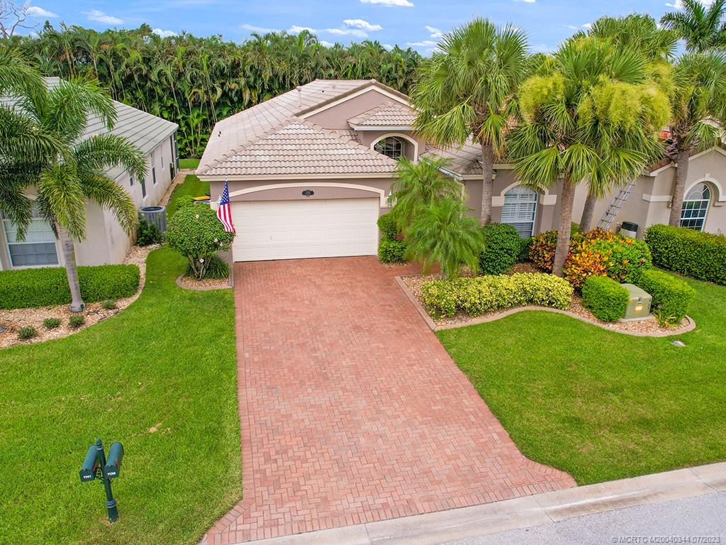 1136 Southeast Westminster Place Stuart, FL 34997 - Photo 2 of 36 a aerial view of a house with a yard and potted plants