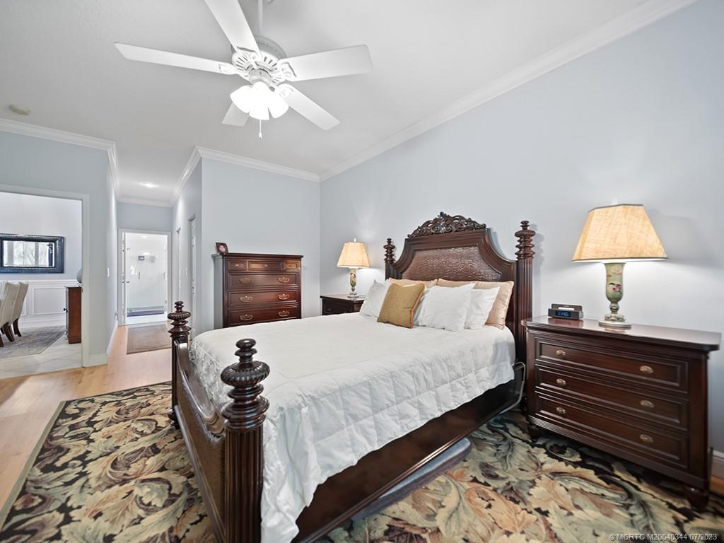 1136 Southeast Westminster Place Stuart, FL 34997 - Photo 22 of 36 a bedroom with a bed and a dresser