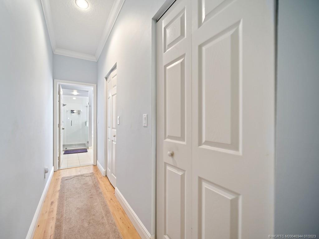 1136 Southeast Westminster Place Stuart, FL 34997 - Photo 24 of 36 a view of a hallway with wooden floor and entryway