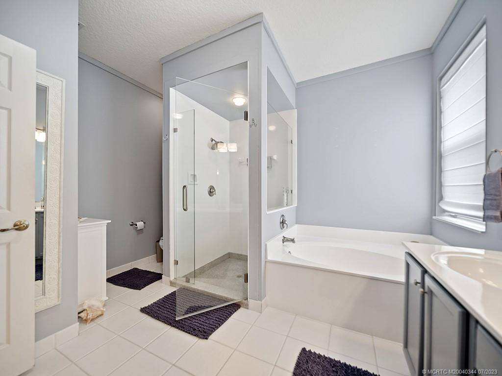 1136 Southeast Westminster Place Stuart, FL 34997 - Photo 26 of 36 a bathroom with a sink a toilet and shower