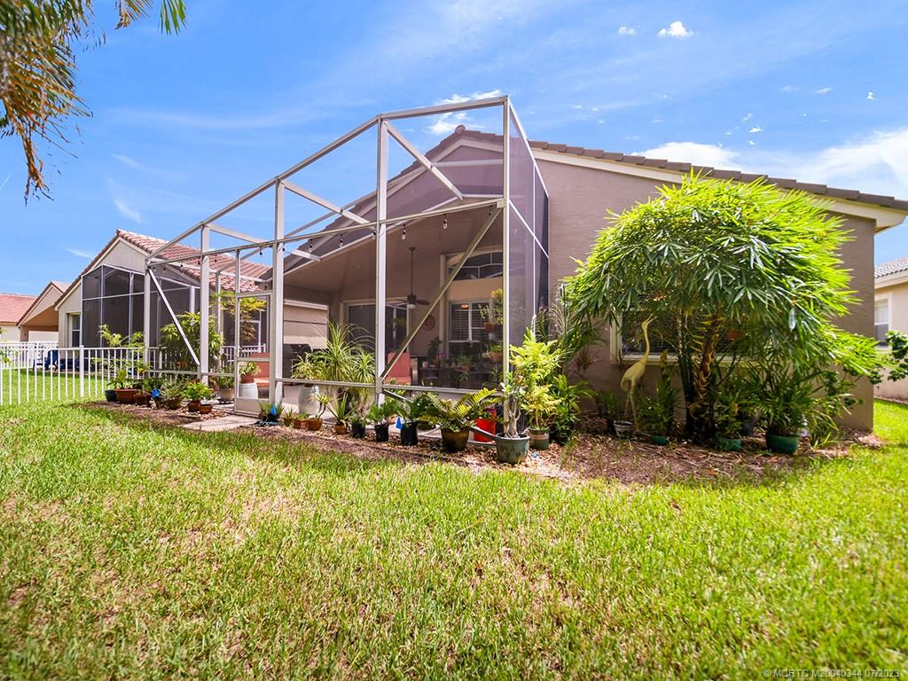 1136 Southeast Westminster Place Stuart, FL 34997 - Photo 29 of 36 a view of a house with backyard and sitting area