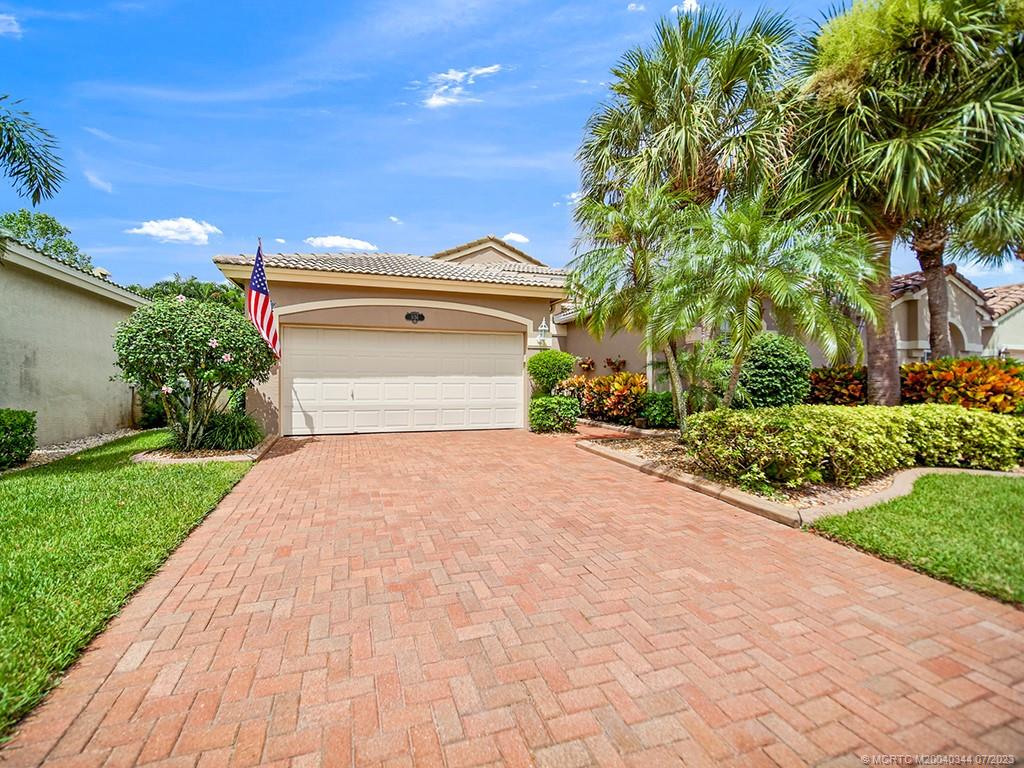 1136 Southeast Westminster Place Stuart, FL 34997 - Photo 3 of 36 a front view of a house with a yard and trees