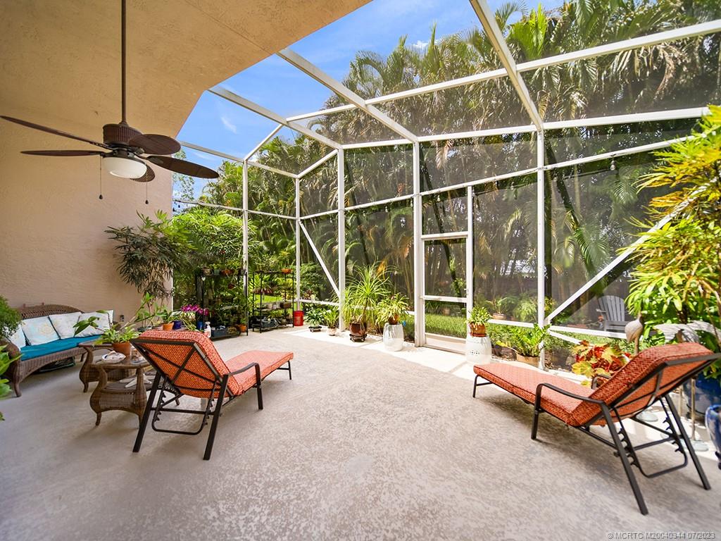 1136 Southeast Westminster Place Stuart, FL 34997 - Photo 32 of 36 a backyard of a house with table and chairs