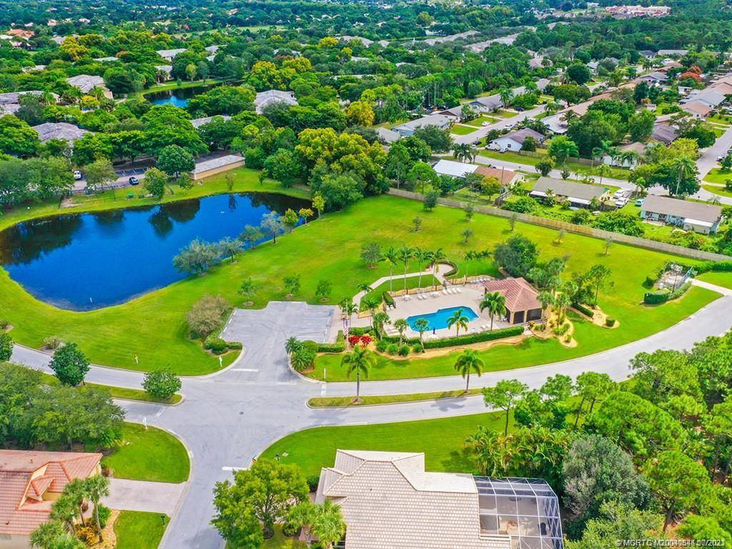 1136 Southeast Westminster Place Stuart, FL 34997 - Photo 33 of 36 an aerial view of a house with a garden and lake view