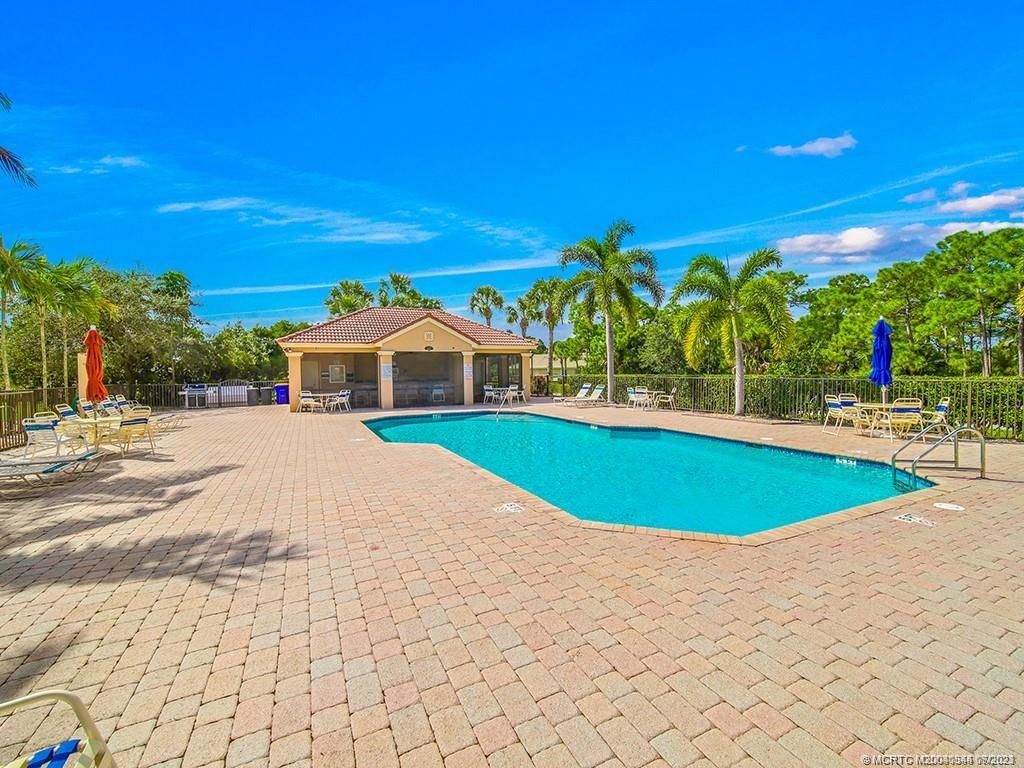 1136 Southeast Westminster Place Stuart, FL 34997 - Photo 34 of 36 a view of a swimming pool with an outdoor space and seating area