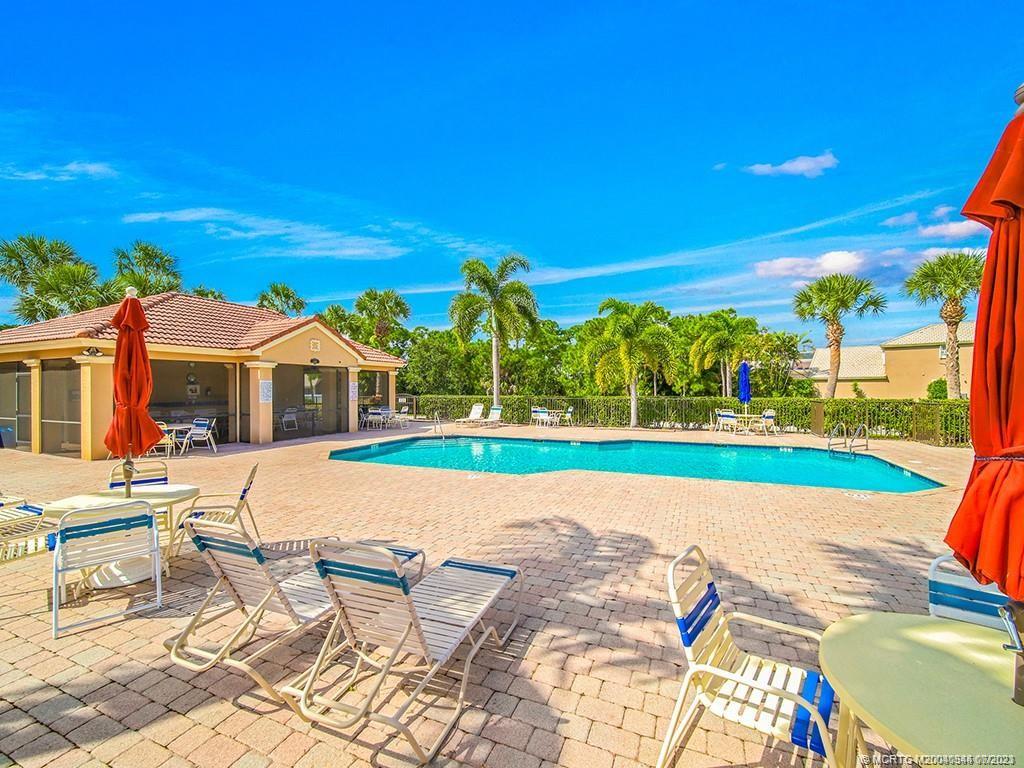 1136 Southeast Westminster Place Stuart, FL 34997 - Photo 35 of 36 a view of swimming pool with lawn chairs and plants