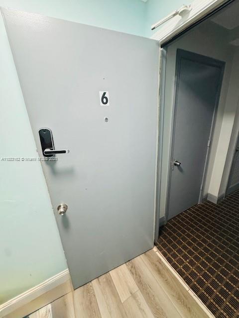 3356 Northeast 33rd Street, Unit 6 Fort Lauderdale, FL 33308 - Photo 21 of 21 a bedroom with a bed and a wooden floor