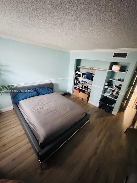 3356 Northeast 33rd Street, Unit 6 Fort Lauderdale, FL 33308 - Photo 8 of 21 a bedroom with a bed and a wooden floor