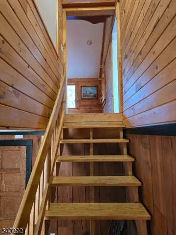 a view of staircase with wooden floor and a floor to ceiling window