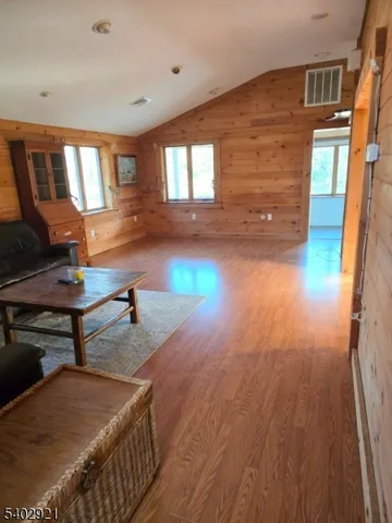 a room with wooden floor and windows