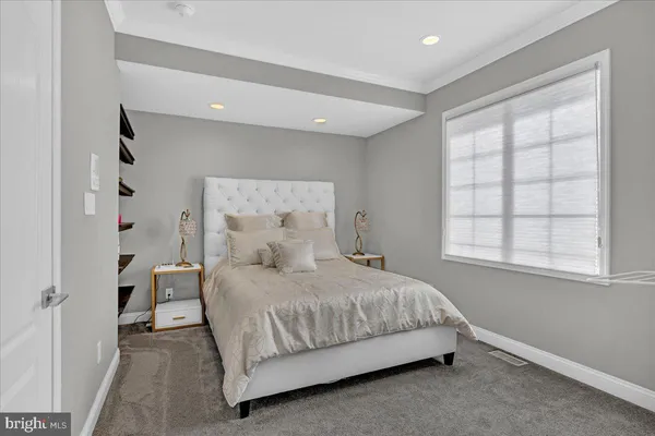 a bedroom with a bed and window