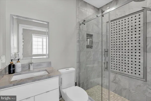 a bathroom with a sink toilet and shower