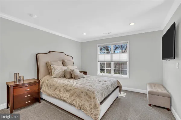a bedroom with a bed and a couch