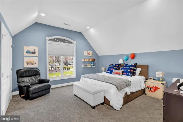 a bedroom with a bed and a couch