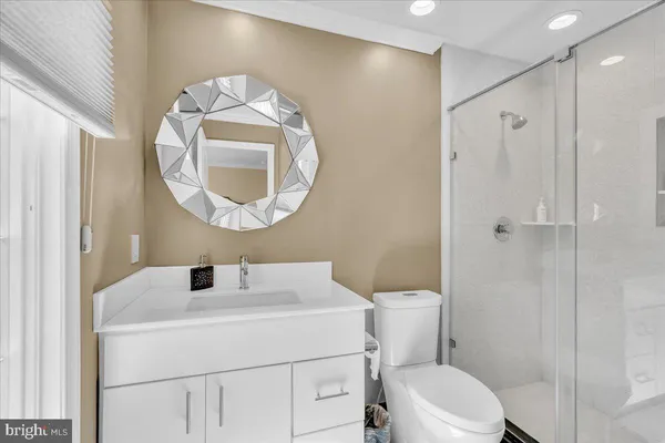 a bathroom with a sink a toilet and a mirror