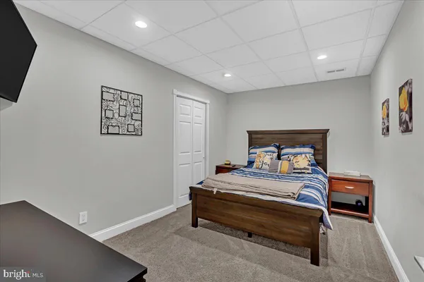 a bedroom with a bed and a wall painting