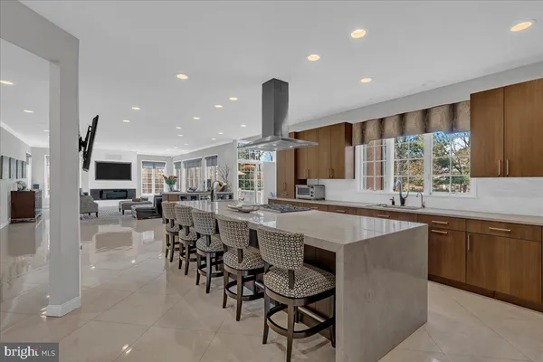a kitchen with lots of counter and chairs