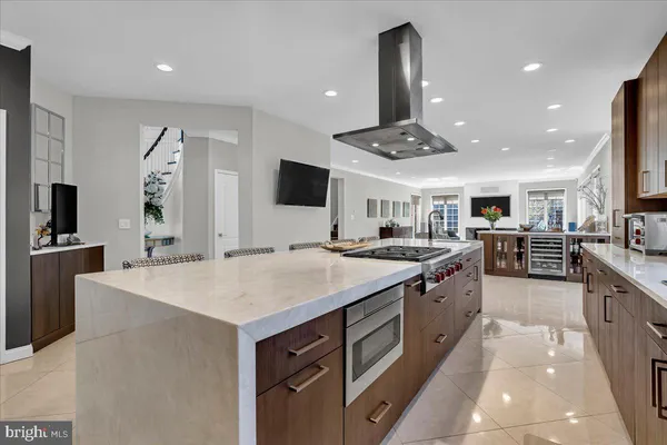 a large kitchen with kitchen island a sink stainless steel appliances and cabinets