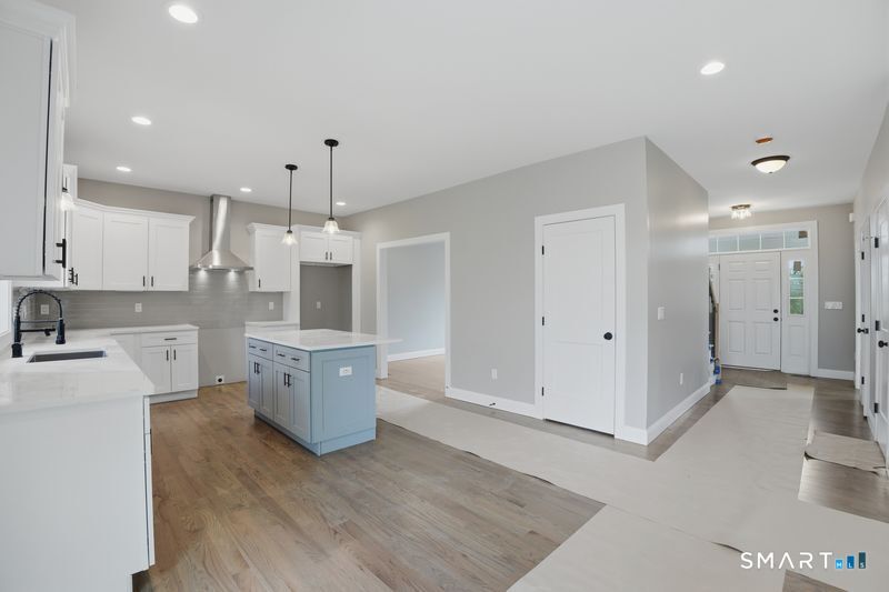 796 Maple Hill Road Naugatuck, CT 06770 - Photo 2 of 35 a large kitchen with white cabinets and wooden floor