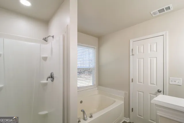 a bathroom with a bathtub and a shower