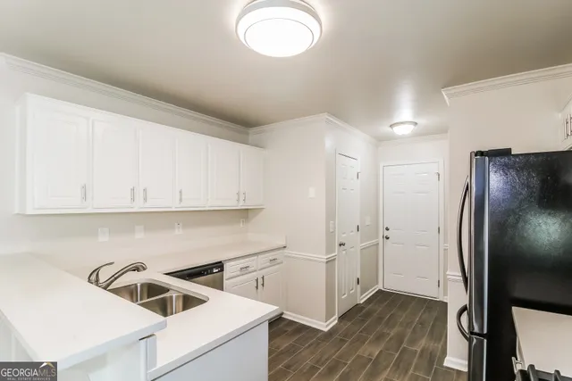 a kitchen with cabinets and stainless steel appliances