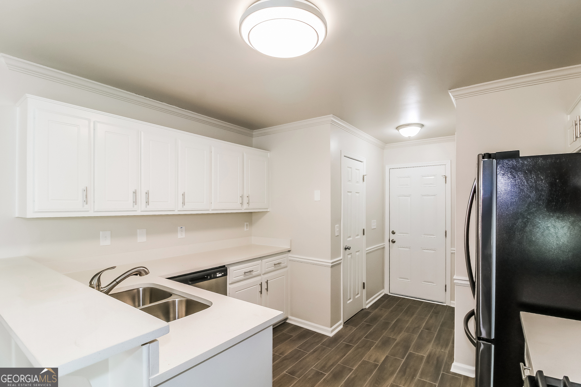 355 Freeman Drive Covington, GA 30016 - Photo 7 of 17 a kitchen with cabinets and stainless steel appliances