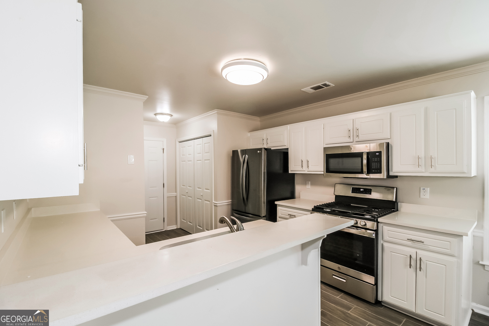 355 Freeman Drive Covington, GA 30016 - Photo 8 of 17 a kitchen with kitchen island a sink stainless steel appliances and cabinets