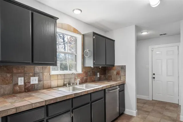 a kitchen with a sink and a window