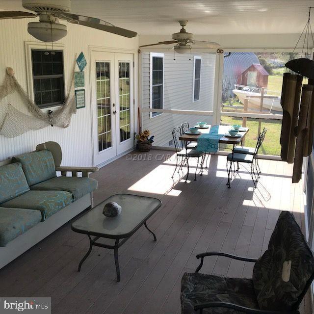2700 Elsey Road Nanticoke, MD 21840 - Photo 29 of 43 a living room with furniture a flat screen tv and a table