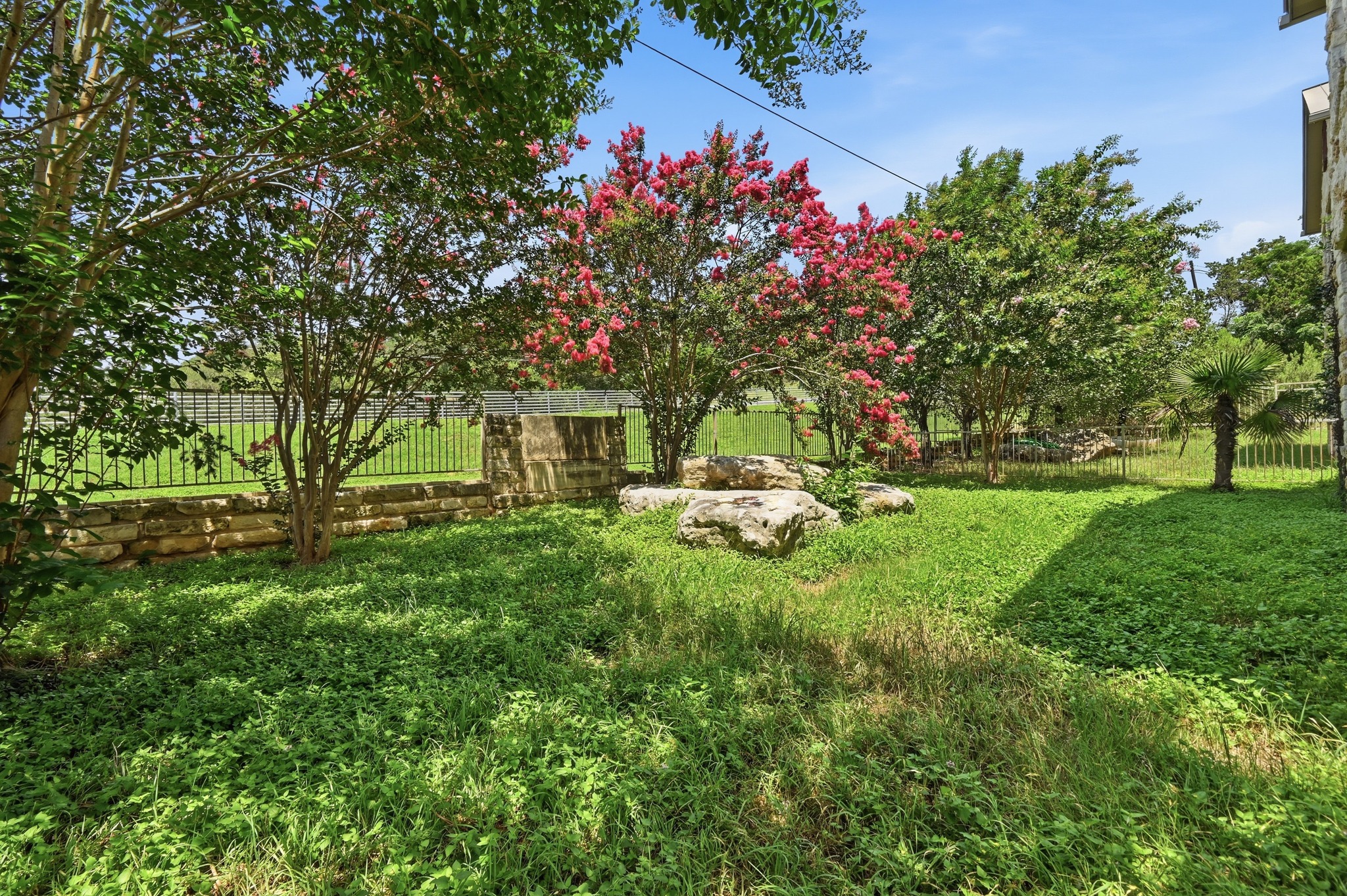592 Farm To Market 967, Unit B Buda, TX 78610 - Photo 24 of 26 Enjoy a private, low-maintenance backyard with charming landscaping and just the right amount of space to relax, entertain, or let pets play.