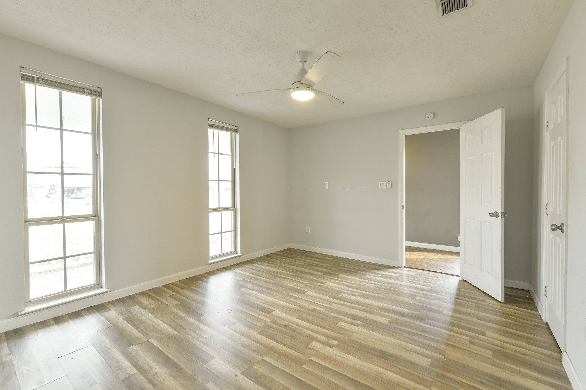 1210 Airline North Rosharon, TX 77583 - Photo 17 of 19 an empty room with wooden floor and windows