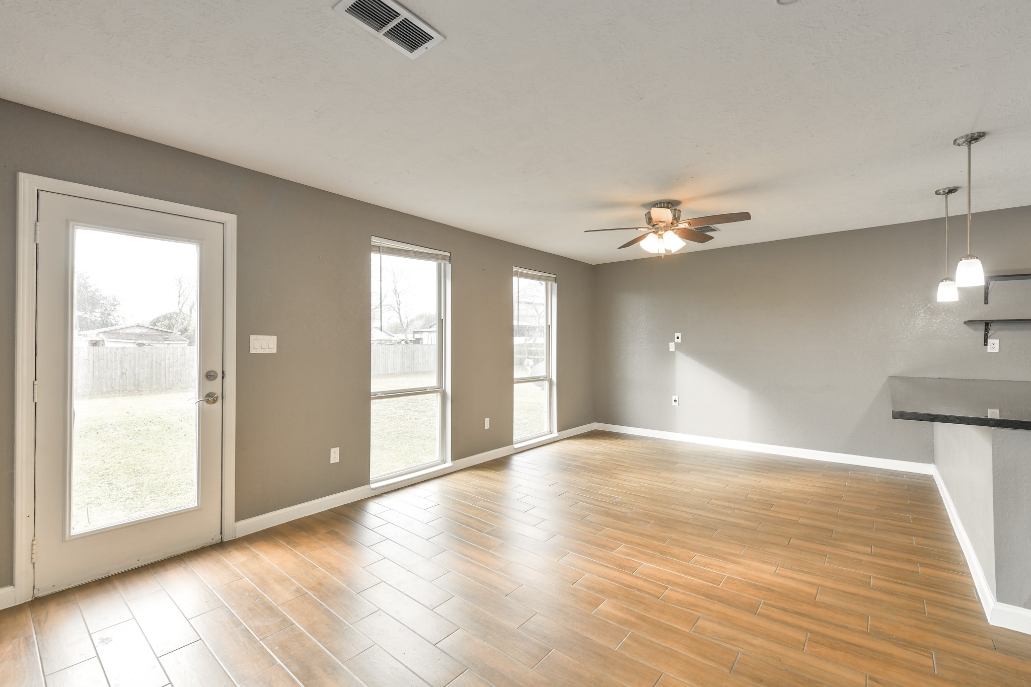 1210 Airline North Rosharon, TX 77583 - Photo 7 of 19 a view of an empty room with window and wooden floor