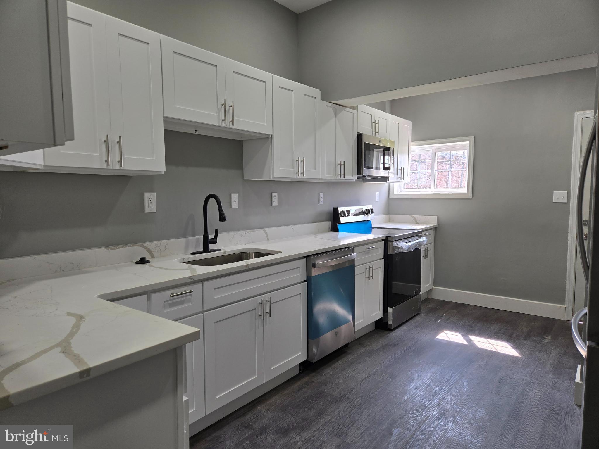 2811 East Preston Street Baltimore, MD 21213 - Photo 1 of 28 a kitchen with stainless steel appliances granite countertop a sink a stove a refrigerator and cabinets