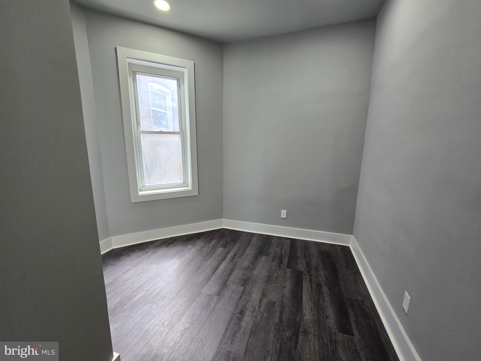 2811 East Preston Street Baltimore, MD 21213 - Photo 12 of 28 an empty room with wooden floor and windows