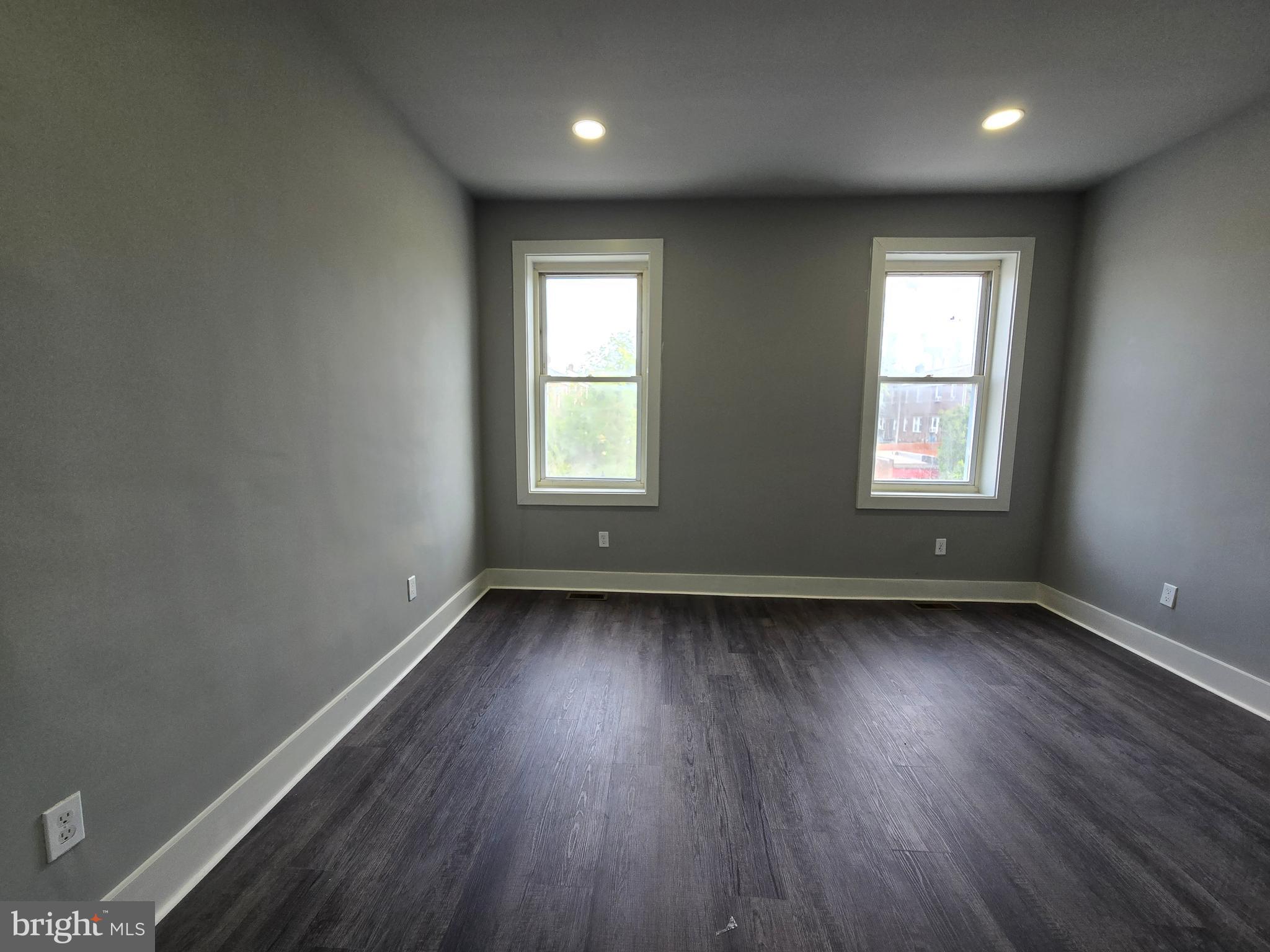 2811 East Preston Street Baltimore, MD 21213 - Photo 14 of 28 an empty room with wooden floor and windows